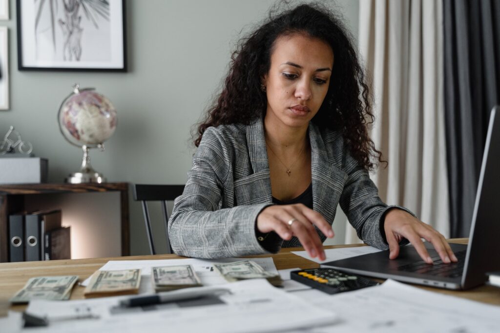 save money working from home woman calculating her savings